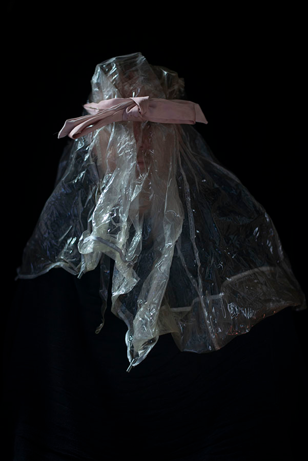 An ethereal clear and reflective form emerging from a black background.