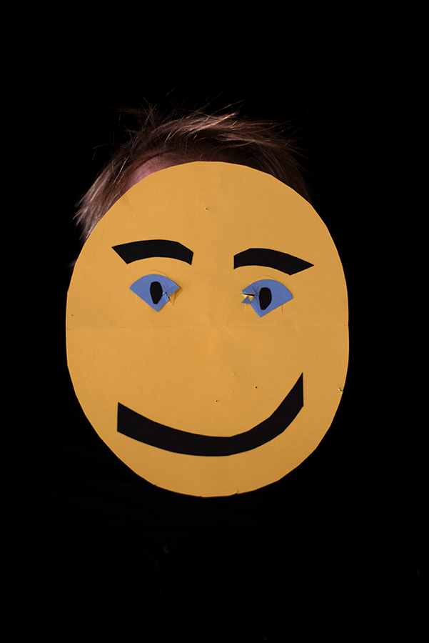 A round yellow face made of construction paper.