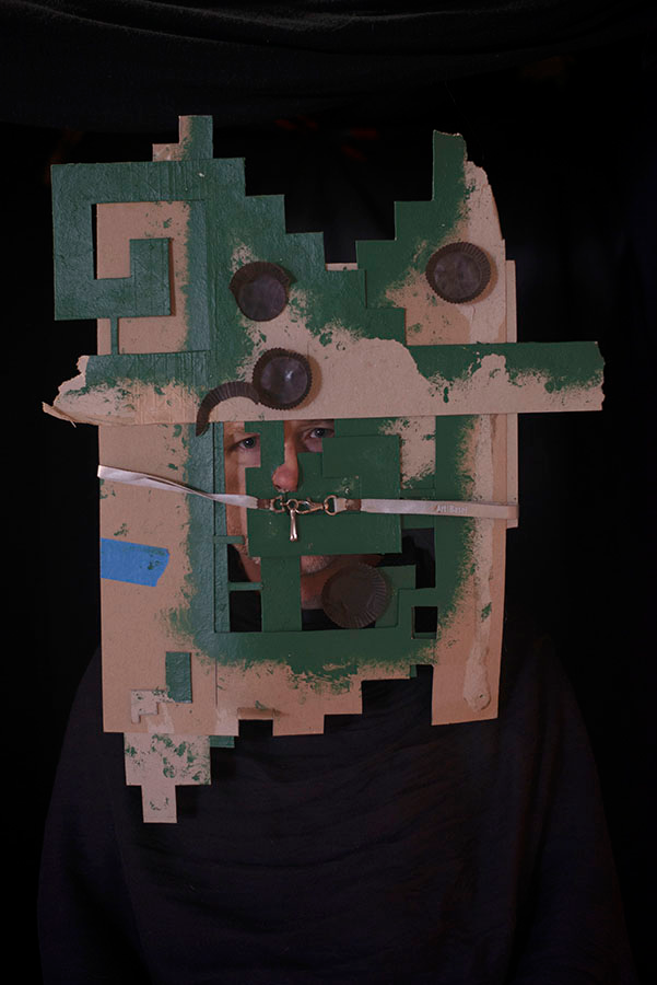 A mask made of cardboard, with geometric details.