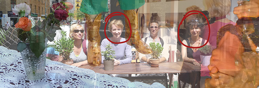 A photo of four women sitting at an outdoor cafe table