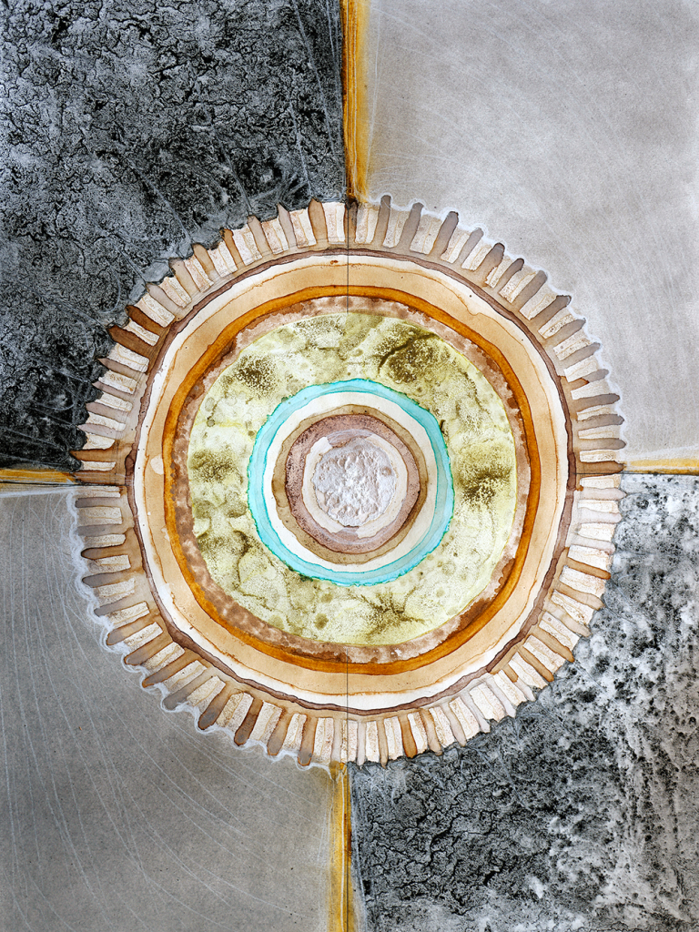 a mixed media drawing dominated by a central circular form over a grid of four square forms background 